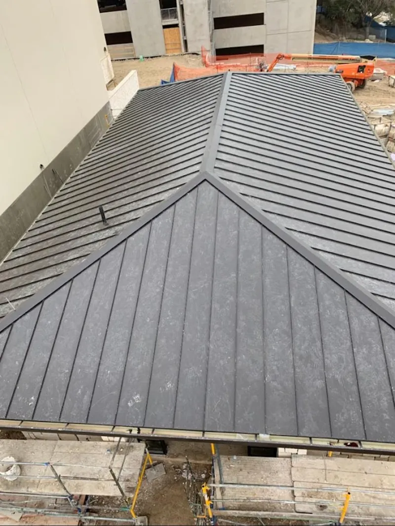 Commercial metal roof construction with crane equipment in Atchison