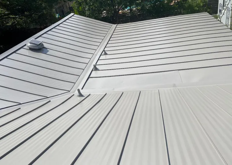 Solar attic fan installed on a metal roof for Roof Ventilation in Atchison